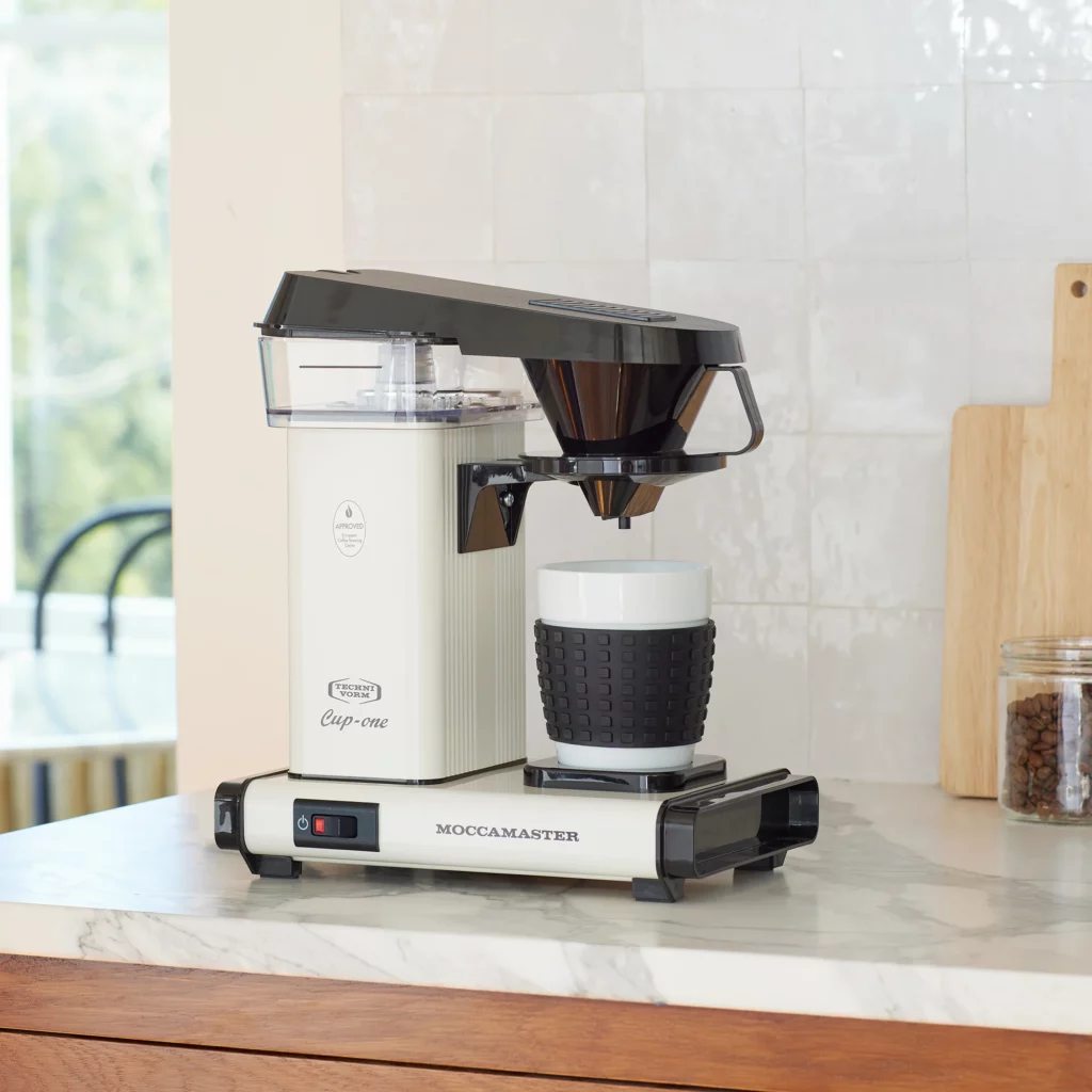moccamaster cup-one coffeemaker on a kitchen counter as an example of 1 of our coffee gifts.