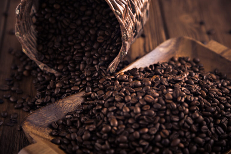 picture of fresh coffee beans on wood tray and in basket like the ones your get from Cooper's Cask Coffee