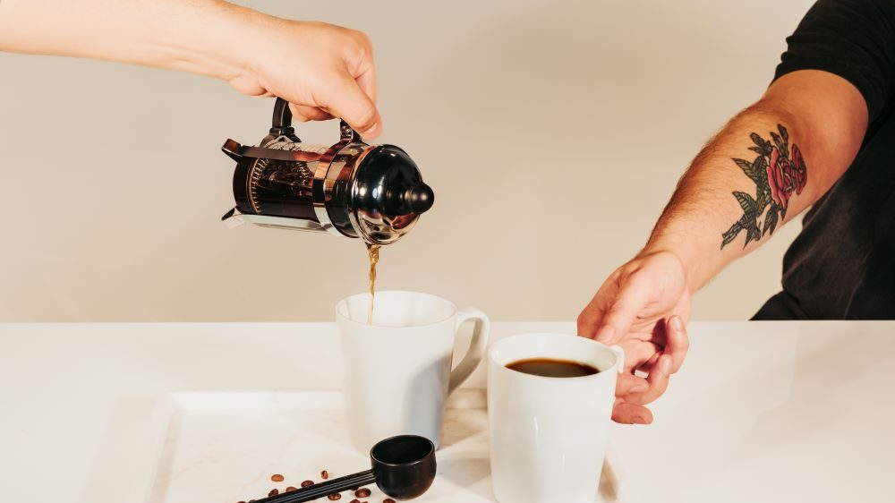 A french press pouring bourbon coffee